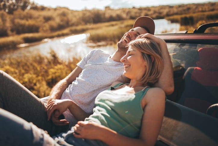 Summer love couple laying in car