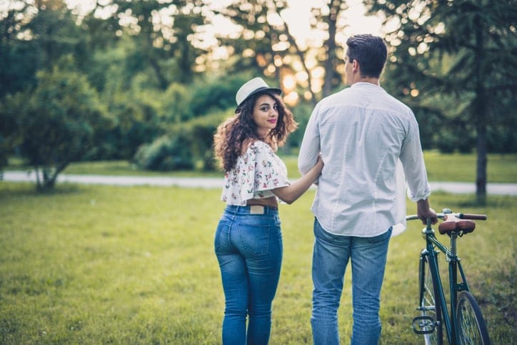 Young couple enjoying in romantic walk on summer evening