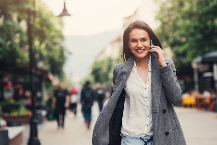Woman talking on the phone outdoors in the city.