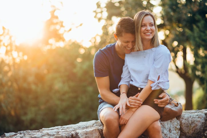 Couple in park hugging and kissing