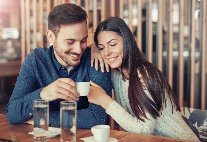 Romantic loving couple drinking coffee, having a date in the cafe. Dating, love, relationships