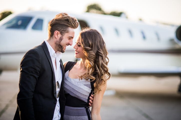 Couple at the airport hugging before boarding plane.
