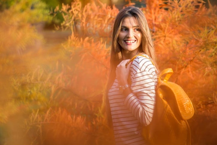 Cute brunette with sunglasses in a park, autumn