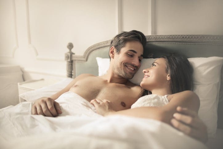 Sweet couple hugging in the bed