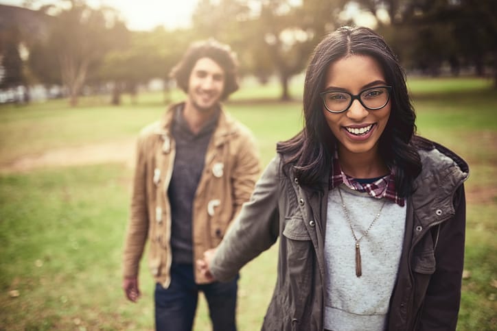 couple holding hands in park