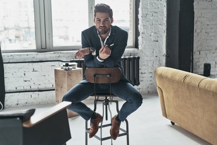 Charming man sitting on a chair