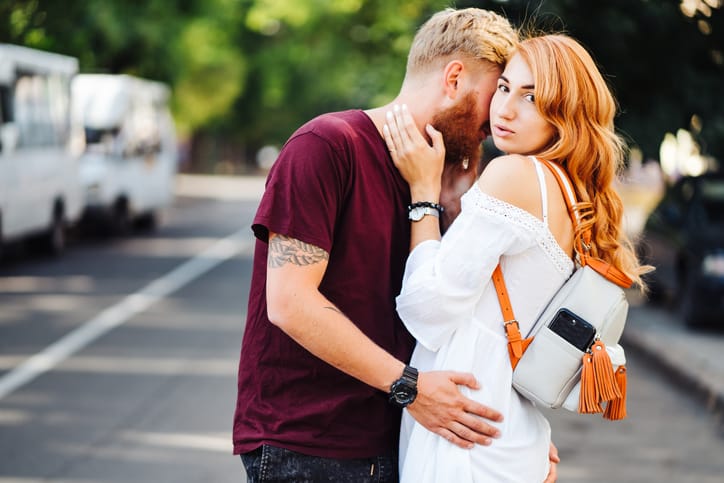 beautiful couple posing outdoors at the camera
