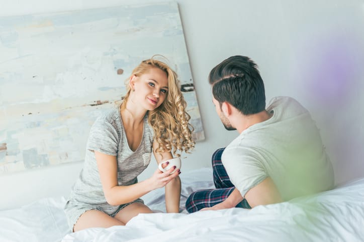 couple drinking coffee in bed