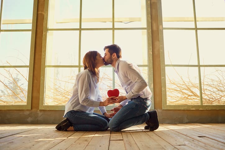 A loving couple with a red heart kissing