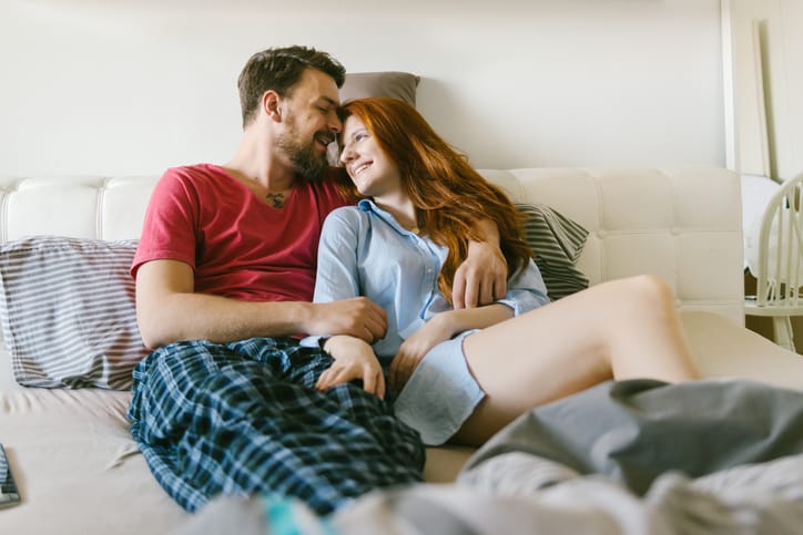 couple laying together on the bed