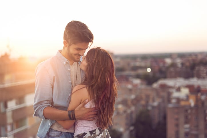 couple kissing on a rooftip