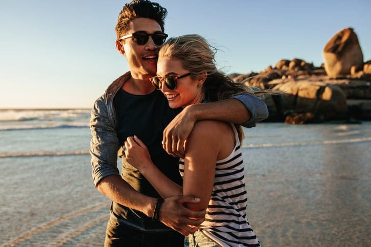 hugging couple on the beach