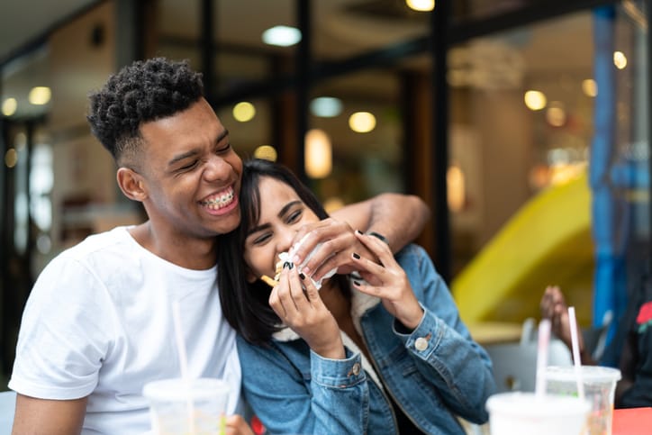 mixed race couple laughing and joking