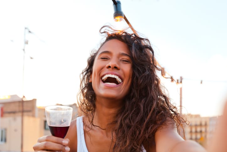 mixed race woman drinking wine