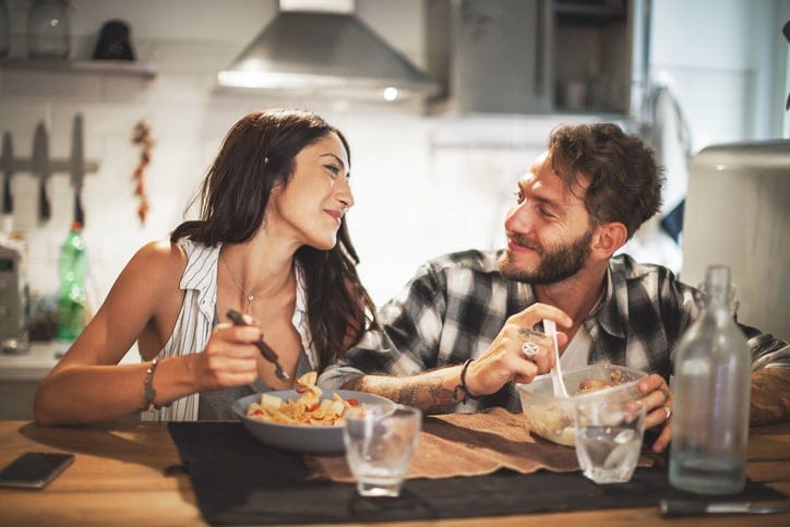 Couple talking over a meal.