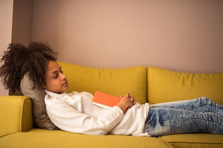 Woman lying on couch.
