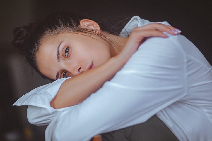 fresh faced woman leaning down