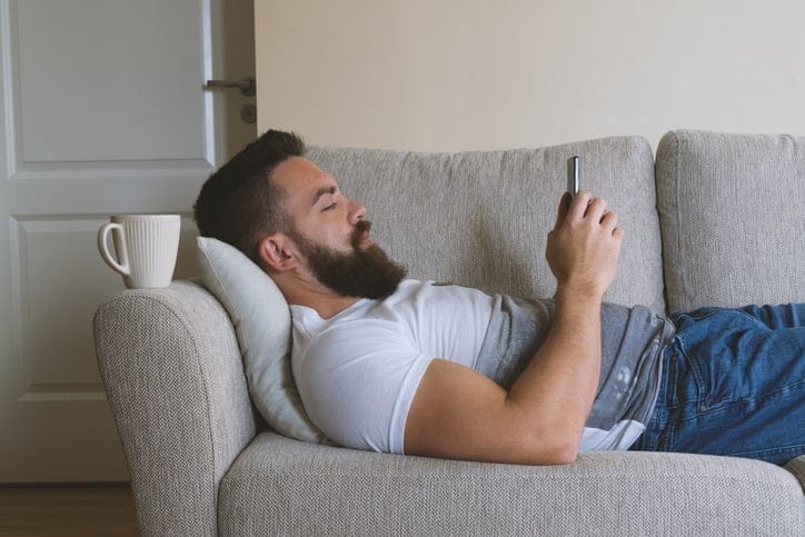 guy laying down texting