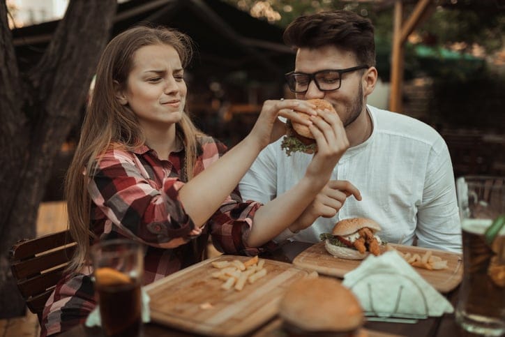 cluple enjoying a burger and fries