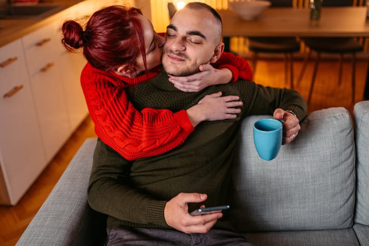 happy couple embracing at home