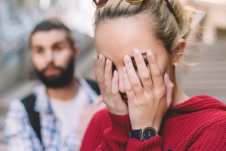 couple arguing woman head in hands