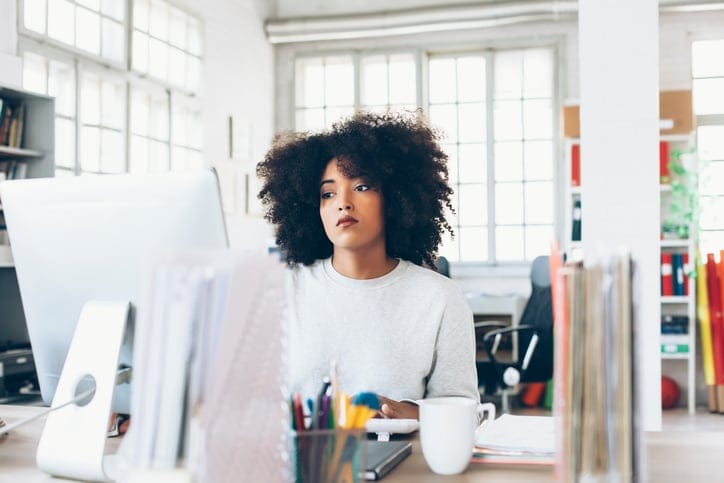 A woman is fired from her office job.