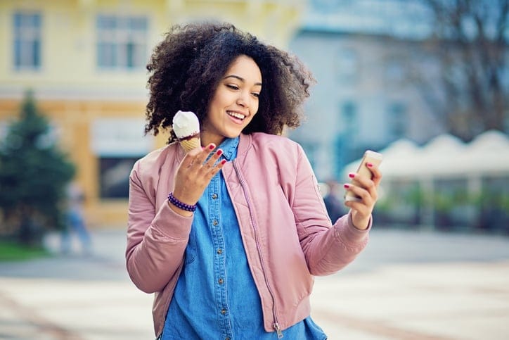 Happy woman eating ice cream.