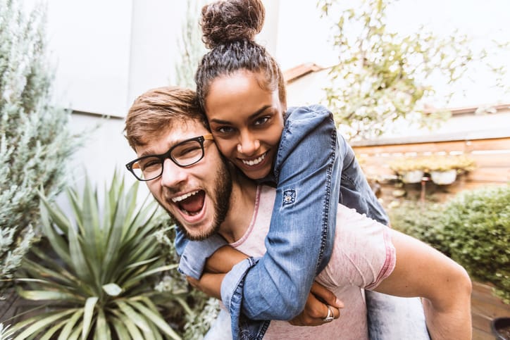 mixed race couple piggy back
