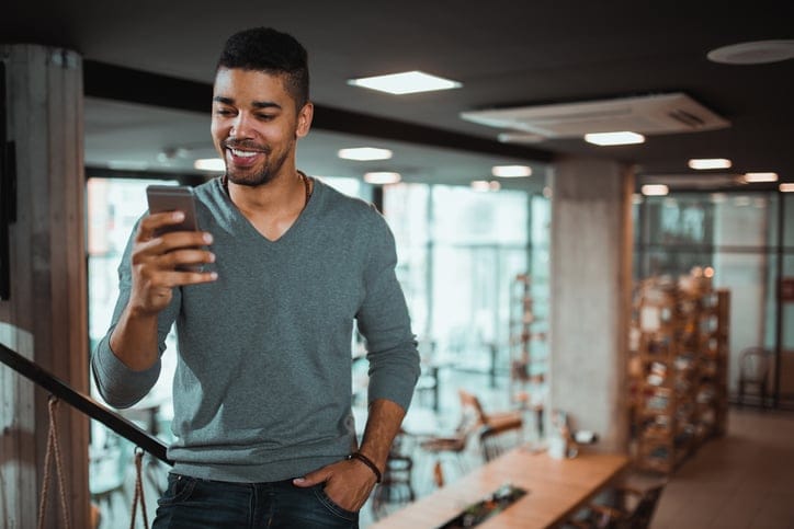 black man looking at his smartphone