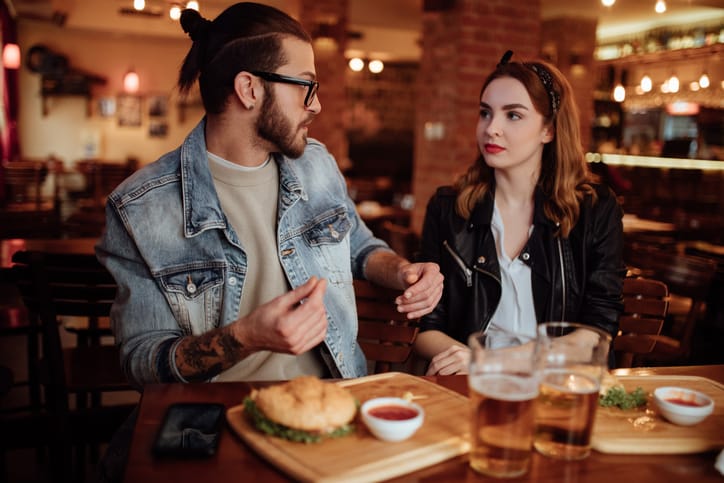 couple looking upset in a cafe
