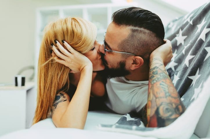 Young Tattooed Couple Kissing
