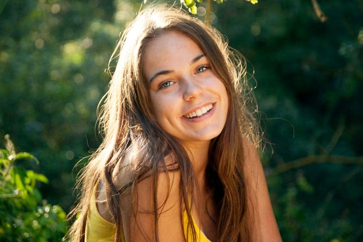long brunette woman smiling