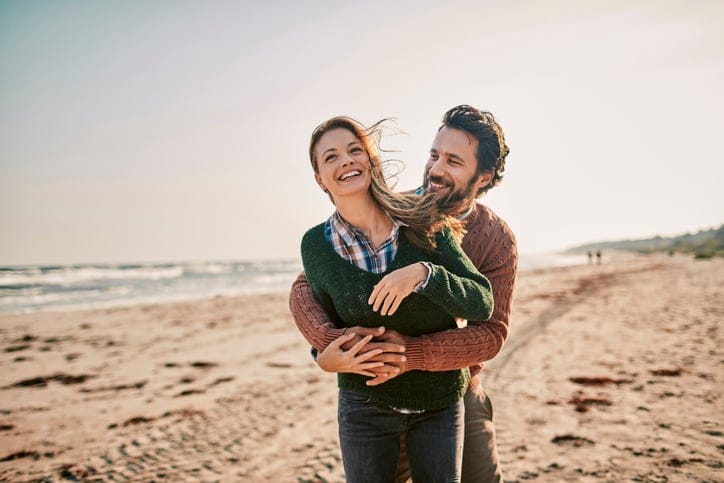 couple outside embracing on a beach