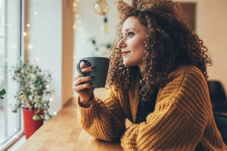 Attractive woman drinking coffee at the cafe.