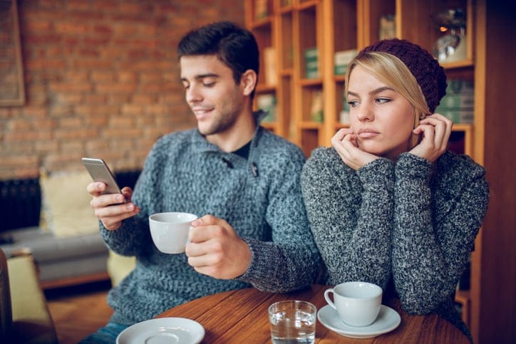 Couple unhappy in a coffee shop.