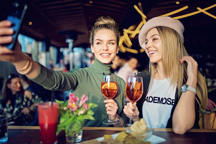 Women drinking at a bar.