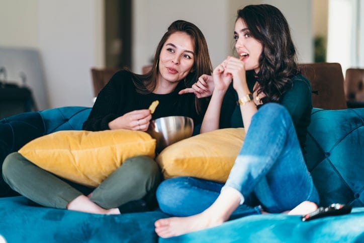 Woman watching TV together.
