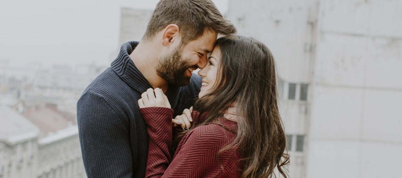 couple facing each other embracing