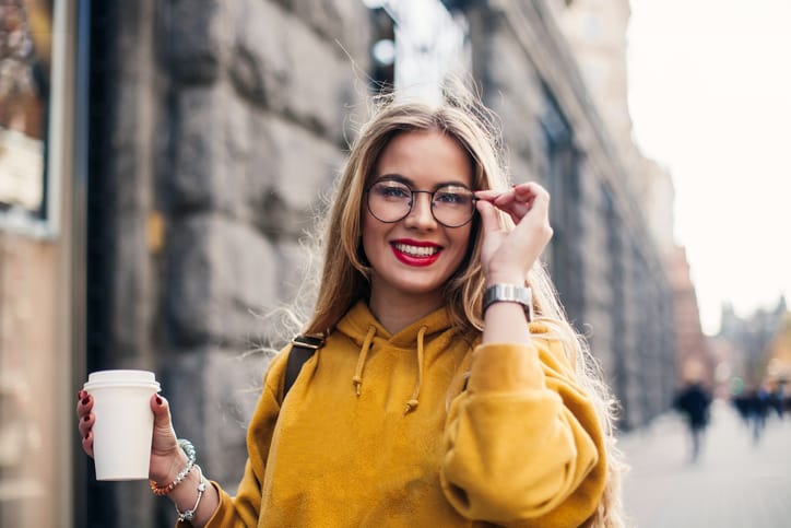 blonde woman glasses smiling