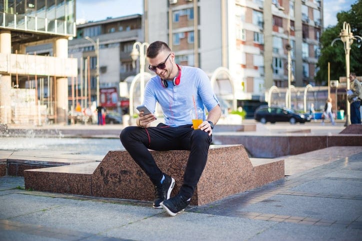 Man sitting and using mobile phone