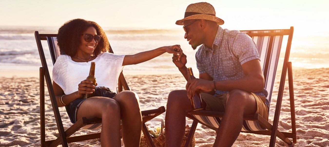 Man and woman on the beach at sunset.