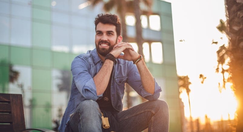 smiling guy sitting outside in sun