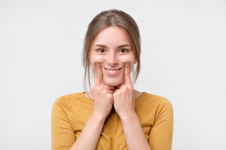 Woman showing her teeth.
