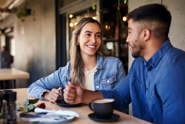 Smiling couple on coffee date.