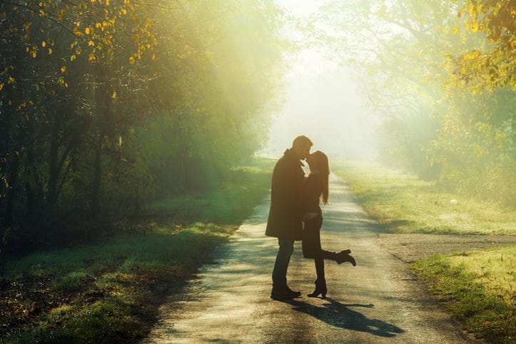 couple kissing on a dusty road