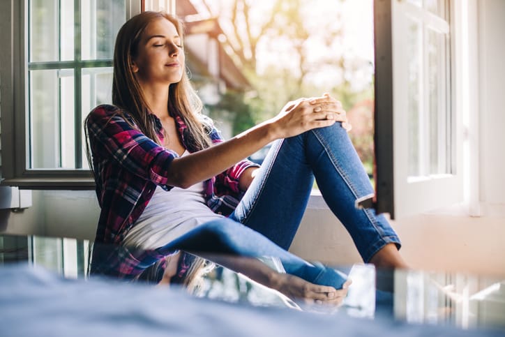 woman sitting on a window sill