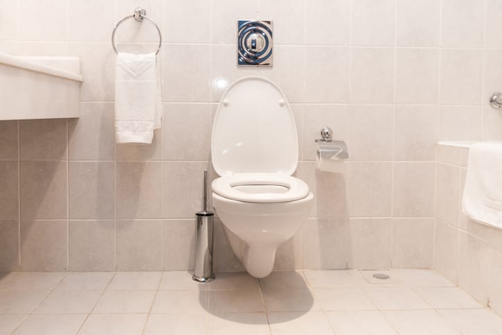 A toilet in a bathroom.