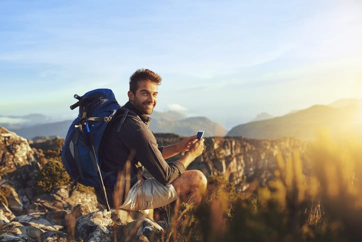 young man sitting on a mountain top