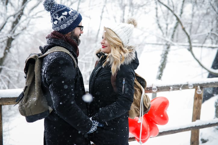 couple looking at each other in the snow