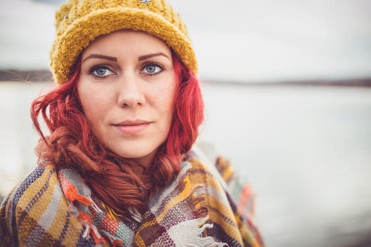 red haired woman wrapped up for winter